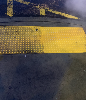 yellow portion of sidewalk